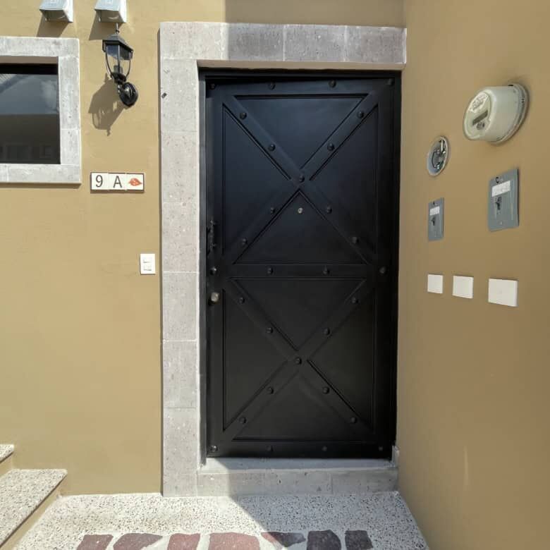 Elegant black door of a modern colonial-style house in La Serena, San Miguel de Allende.