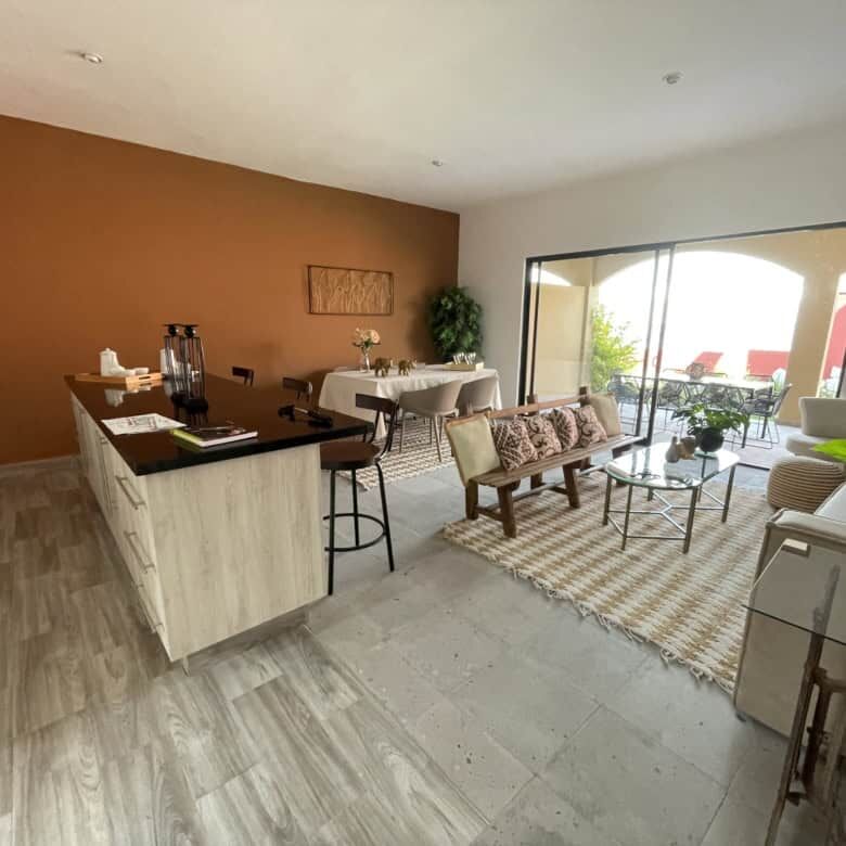 Bright living room with modern decor, large glass doors opening to outdoor patio in La Serena.
