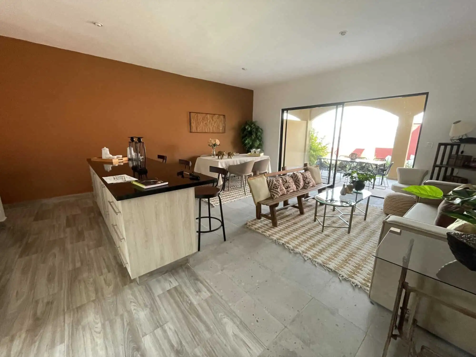 Bright living room with modern decor, large glass doors opening to outdoor patio in La Serena.