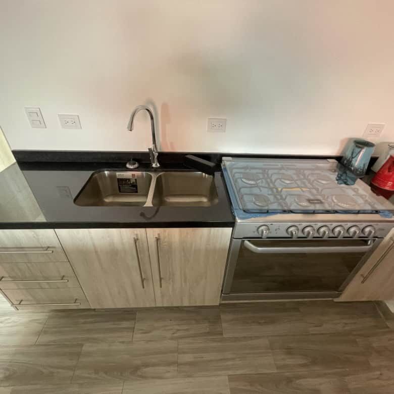 Modern kitchen with sink and stove in a colonial-style home in La Serena, San Miguel de Allende.