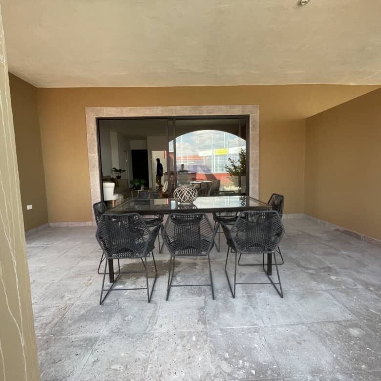 Spacious outdoor patio with dining area in a modern colonial-style home in La Serena, San Miguel de.