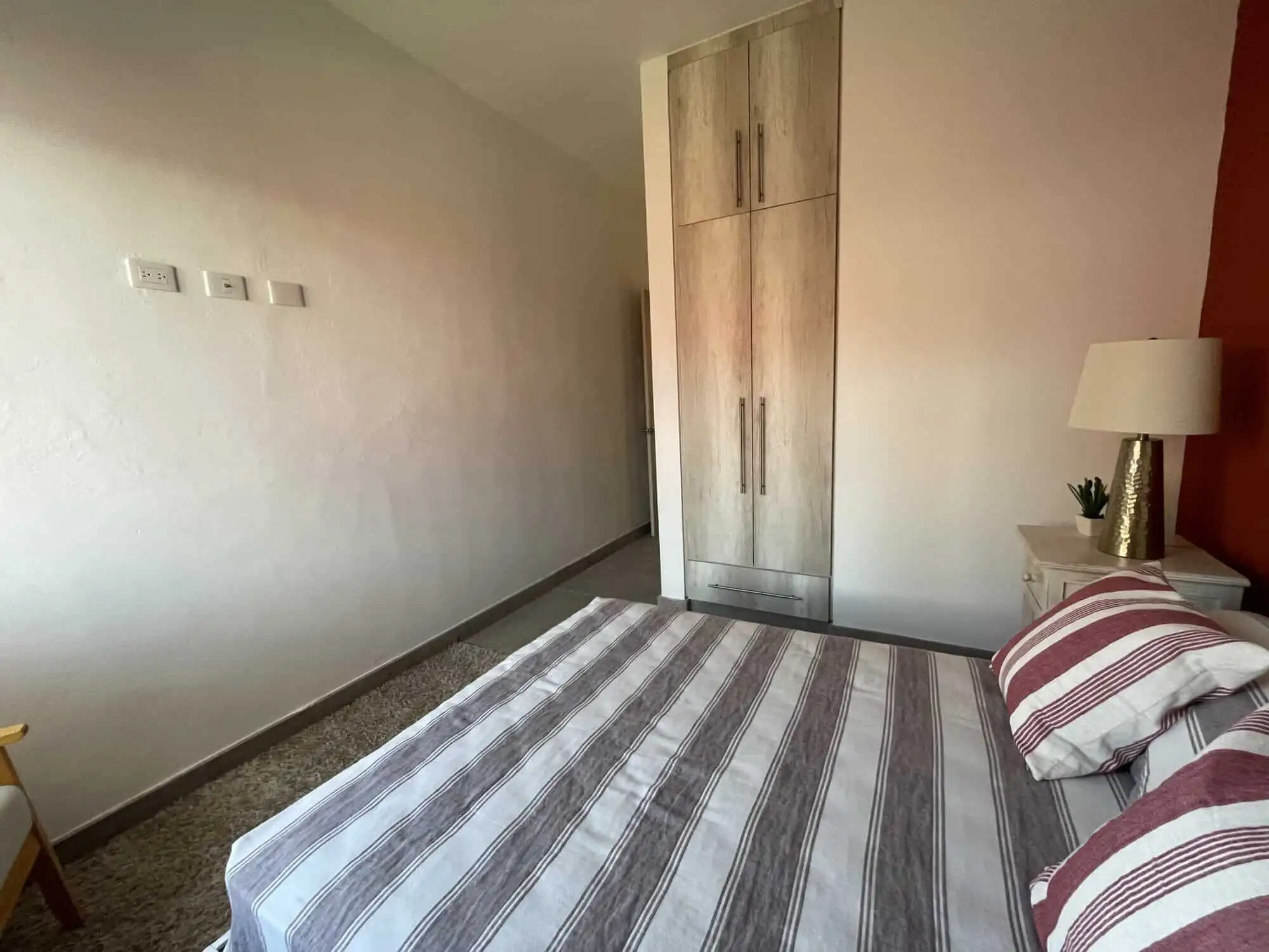 Modern colonial bedroom with a large bed, wooden wardrobe, and cozy decor in La Serena, San Miguel d.