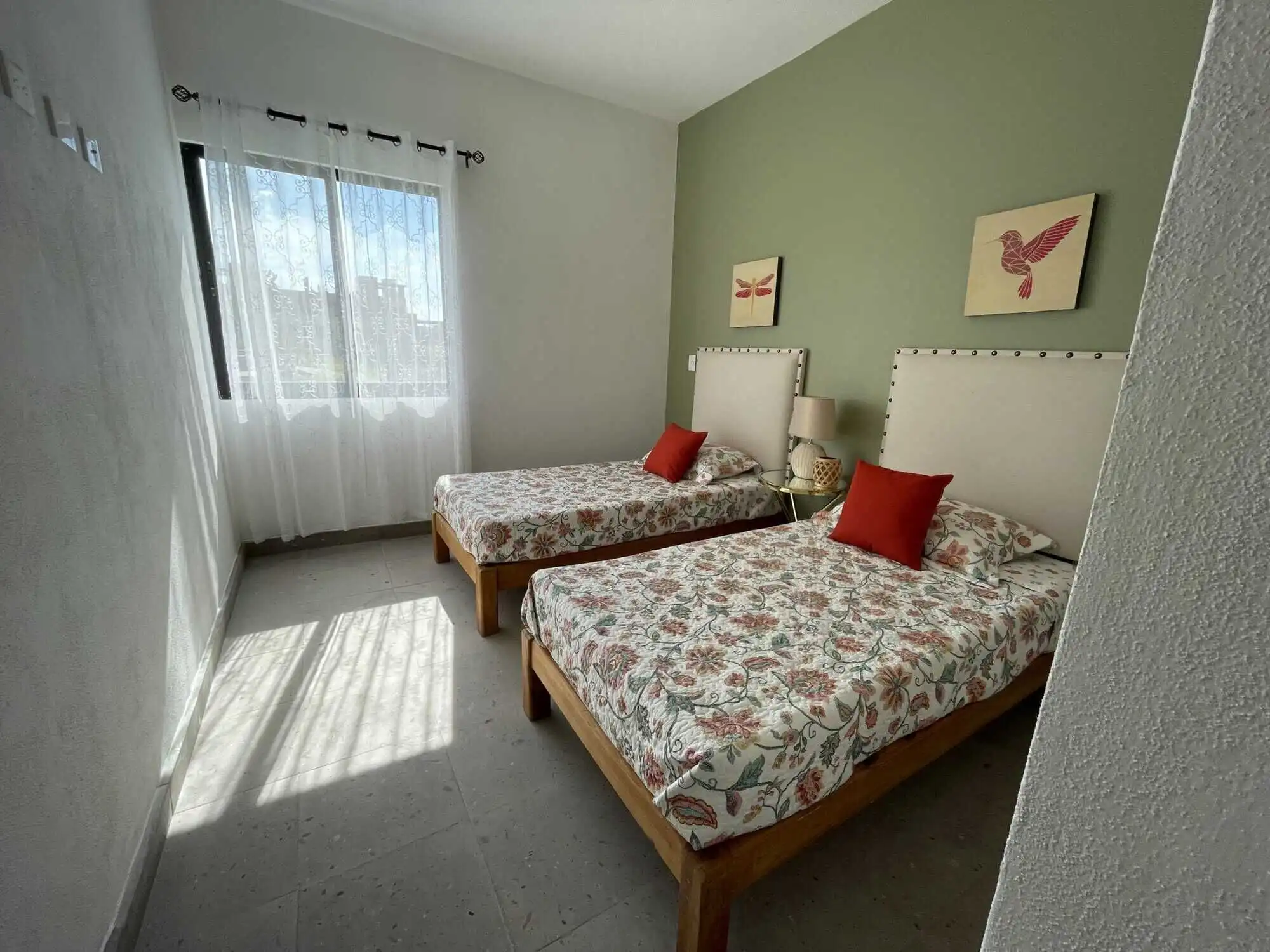 Interior view of a 3-bedroom home in La Serena Residencial, featuring two beds, decorative pillows,.