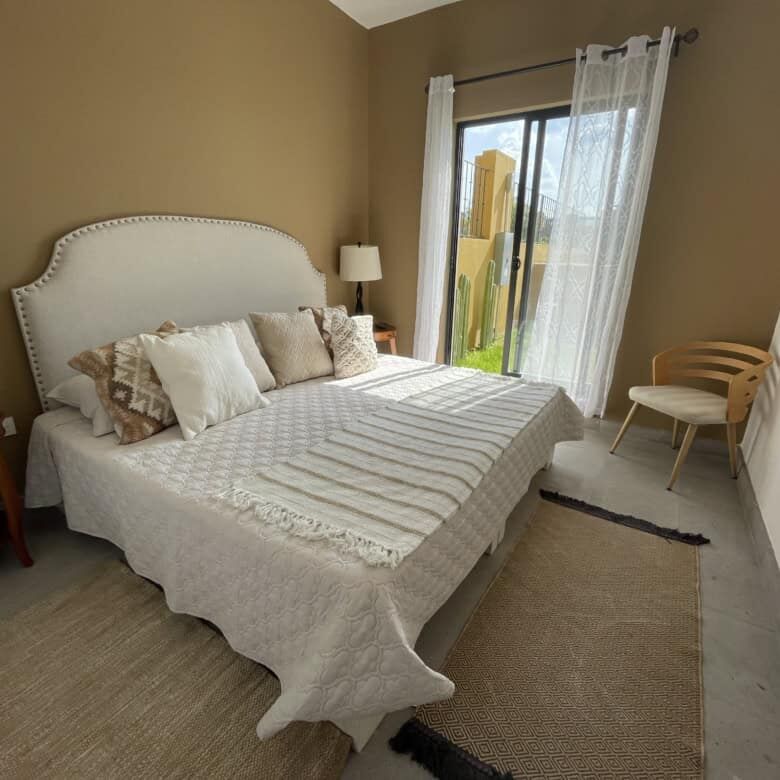 Spacious bedroom with a large bed, neutral decor, and natural light in La Serena Residencial.