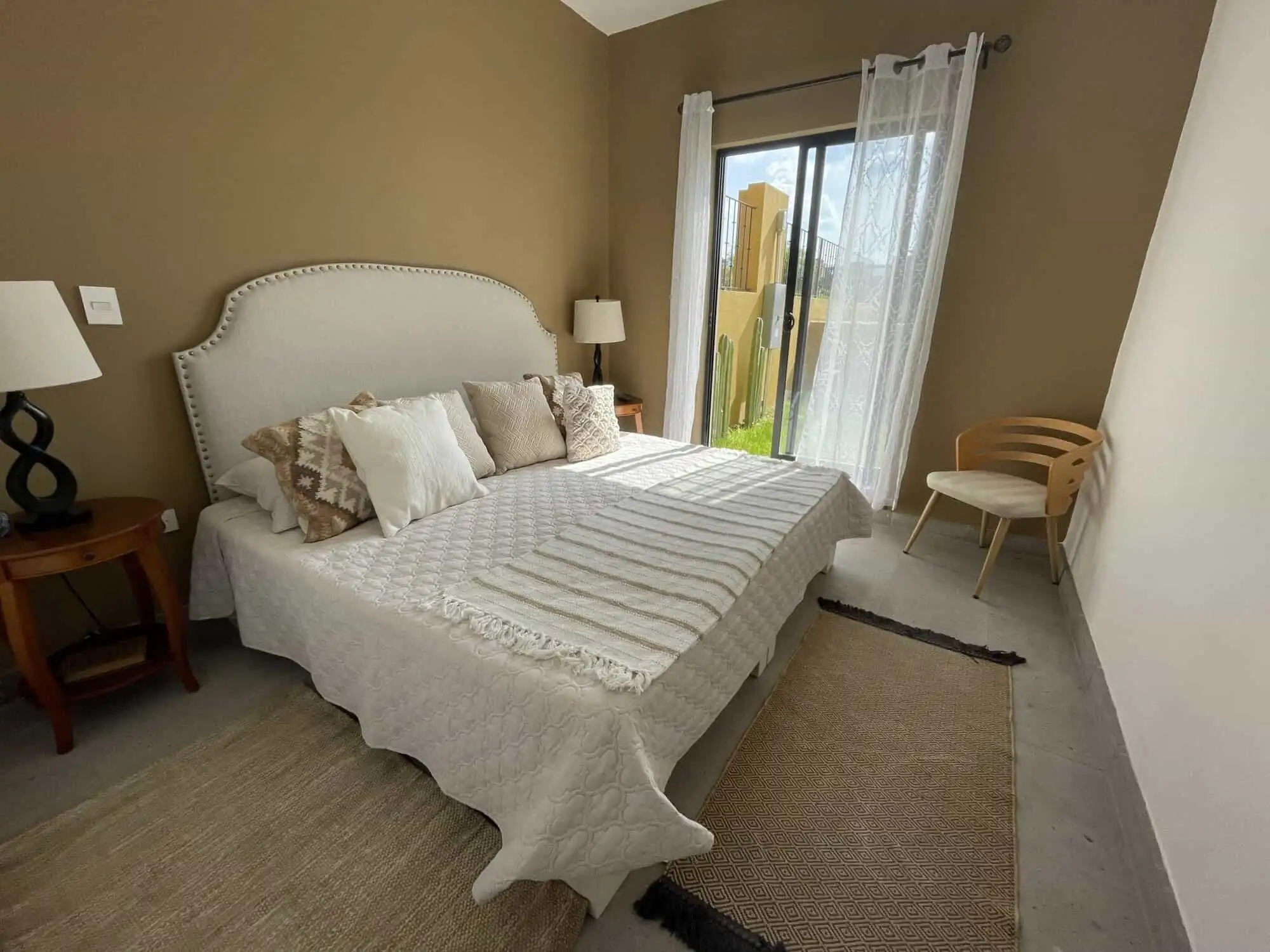 Spacious bedroom with a large bed, neutral decor, and natural light in La Serena Residencial.