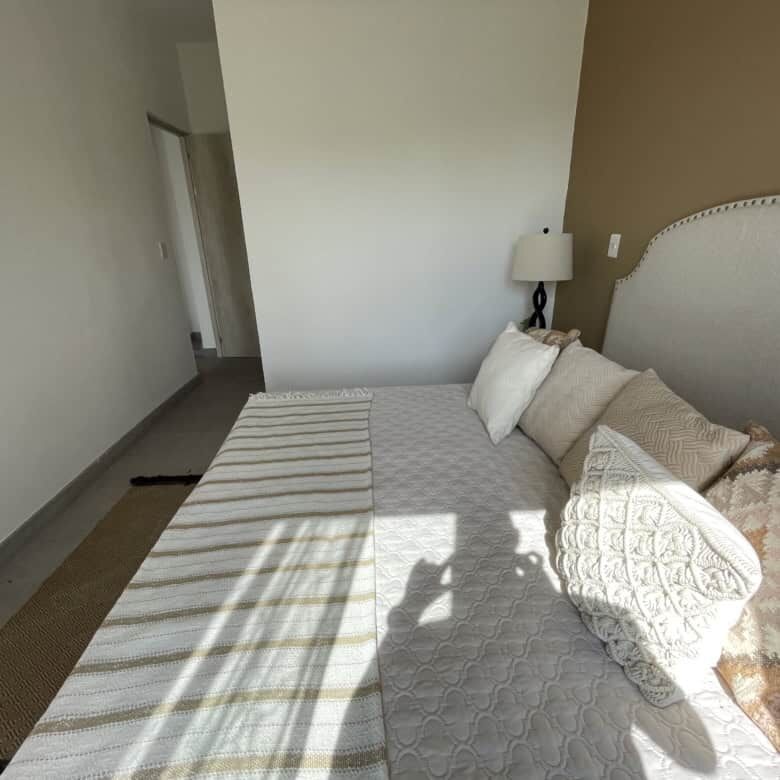 Bright bedroom with neutral decor and sunlight in La Serena Residencial, San Miguel de Allende.