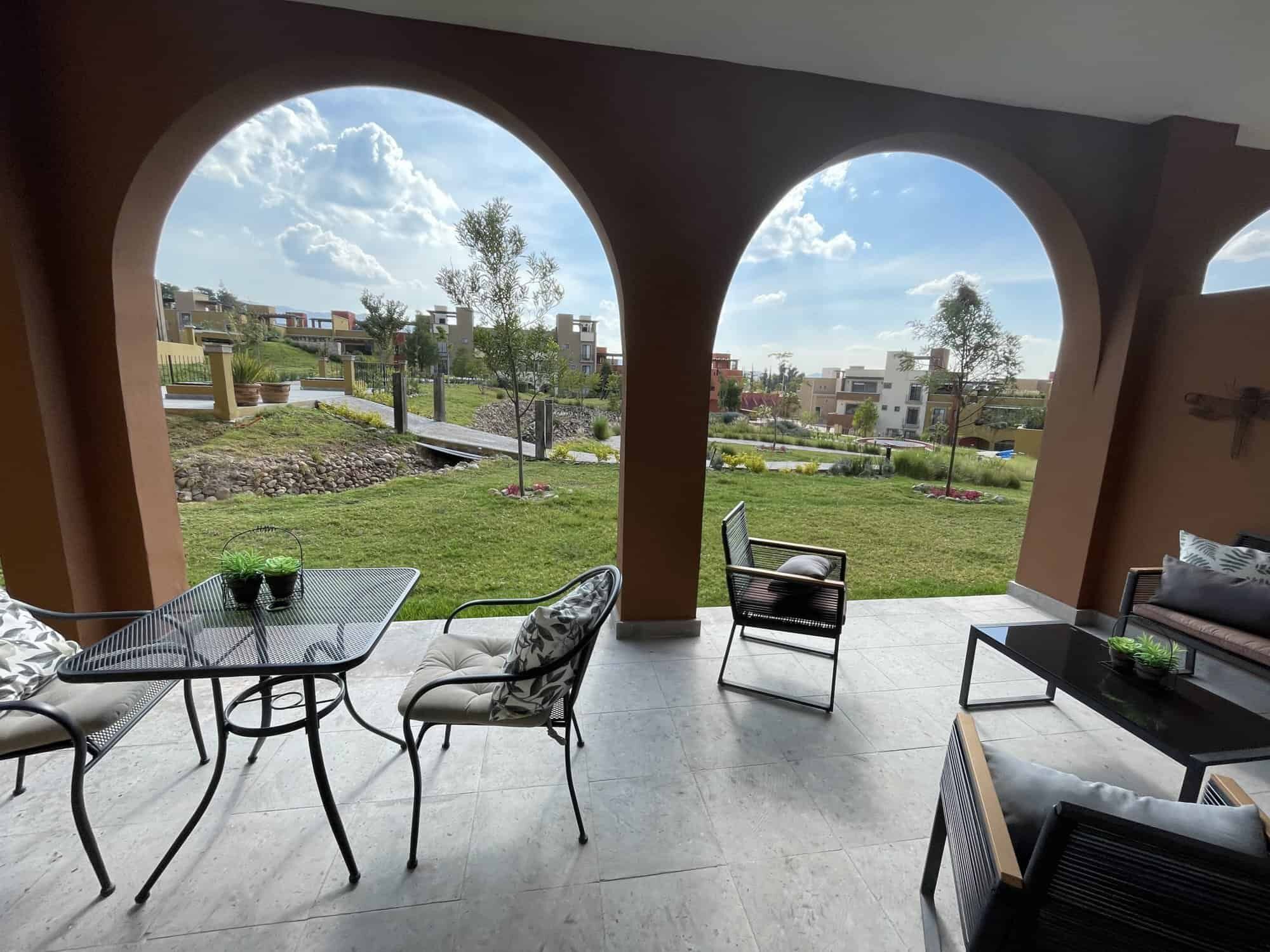 Outdoor patio of a 3-bedroom home in La Serena Residencial, featuring stylish furniture and lush gre.