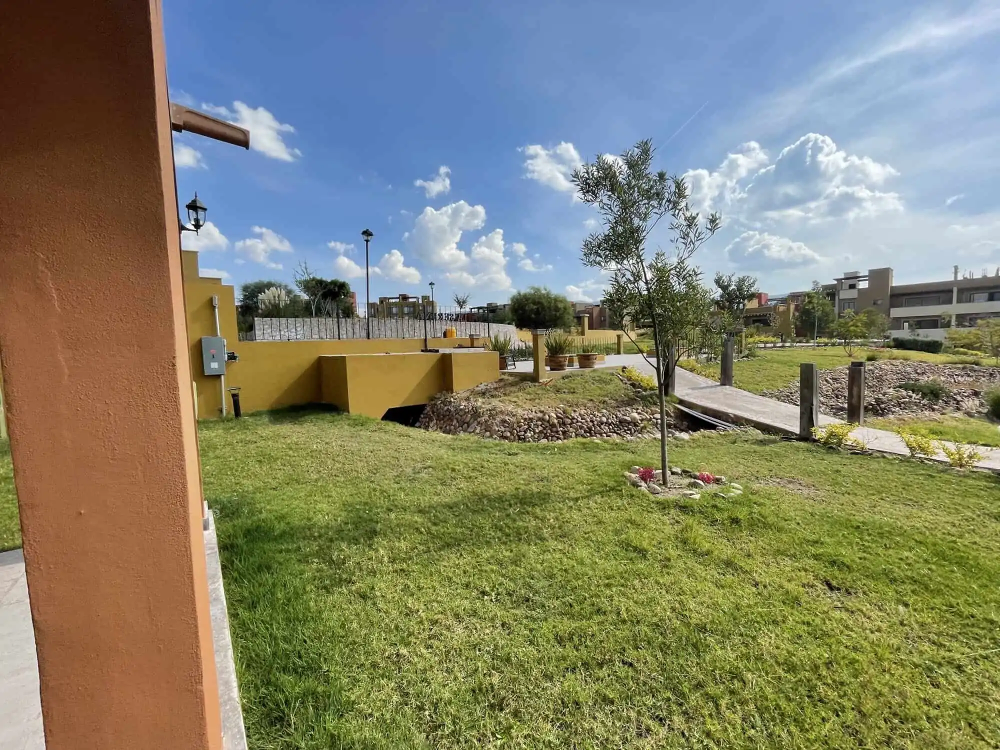 Beautiful outdoor view of La Serena Residencial with green lawn and trees in San Miguel de Allende.