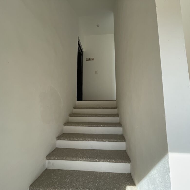 Interior view of a modern 2-bedroom apartment staircase in La Serena Residencial.