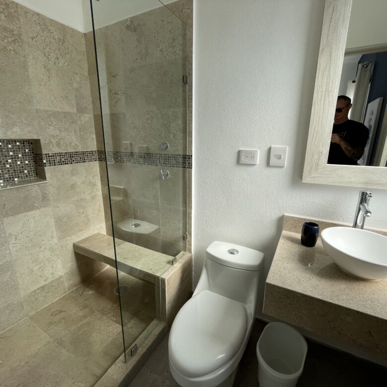 Bright bathroom with walk-in shower and modern fixtures.