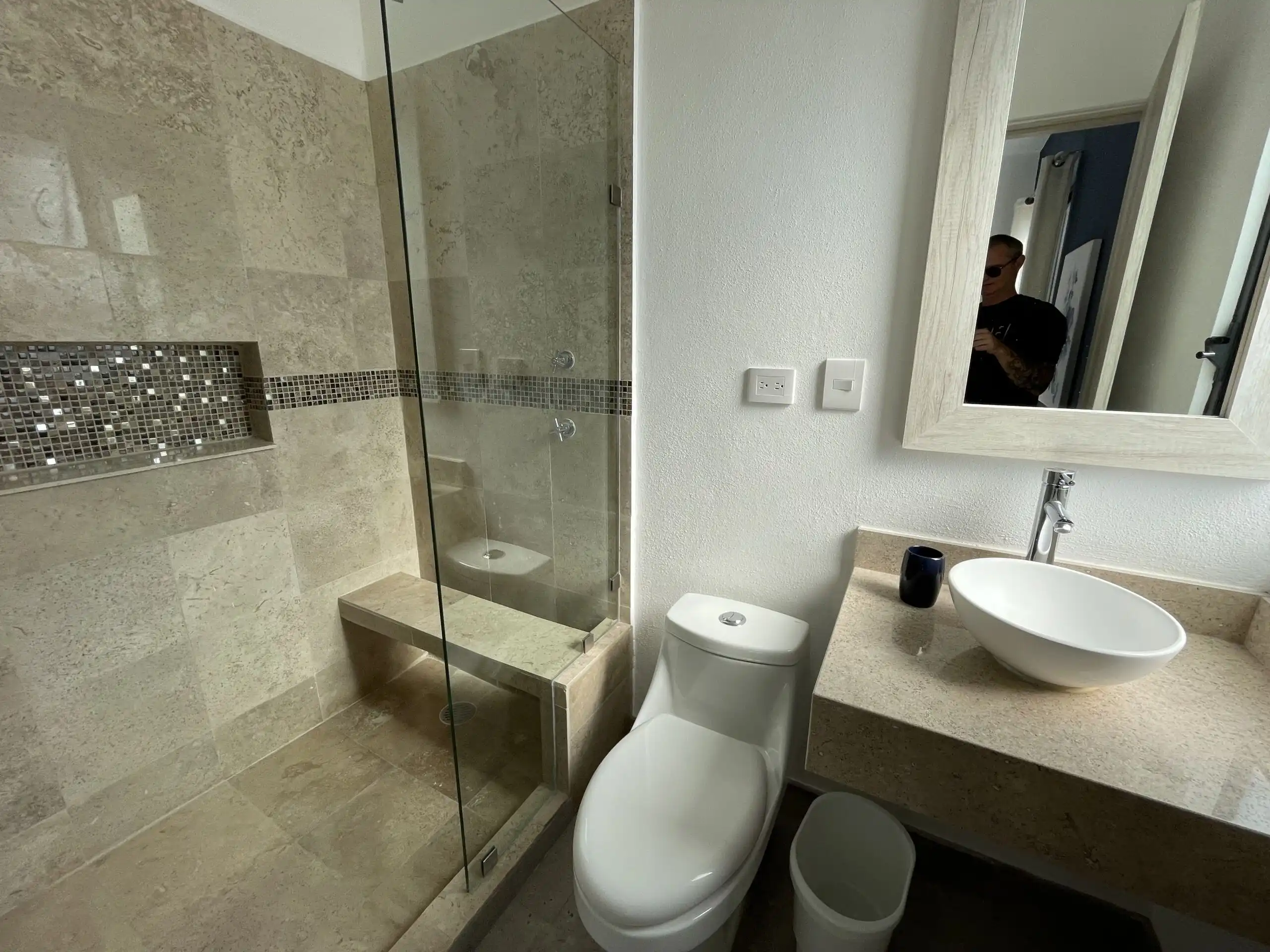 Bright bathroom with walk-in shower and modern fixtures.