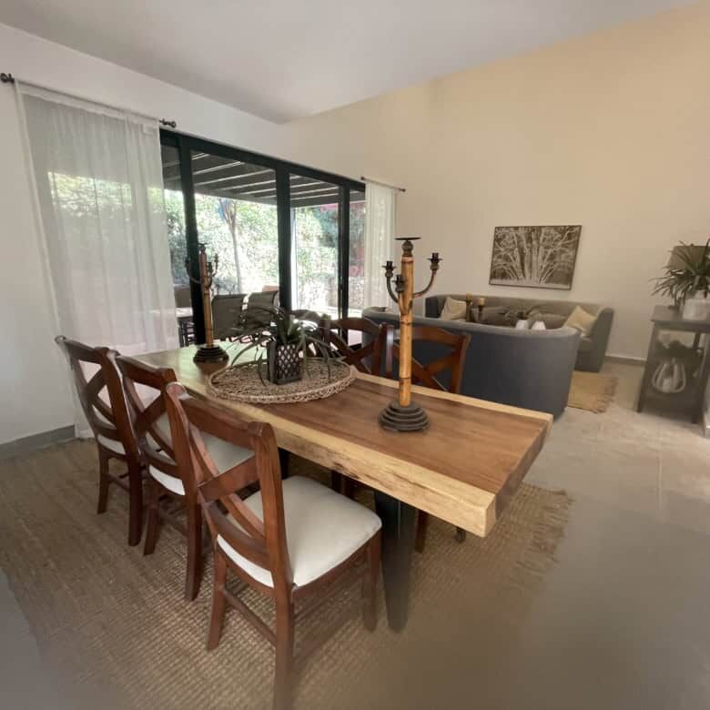 Spacious living room with modern decor, large windows, and access to outdoor views.