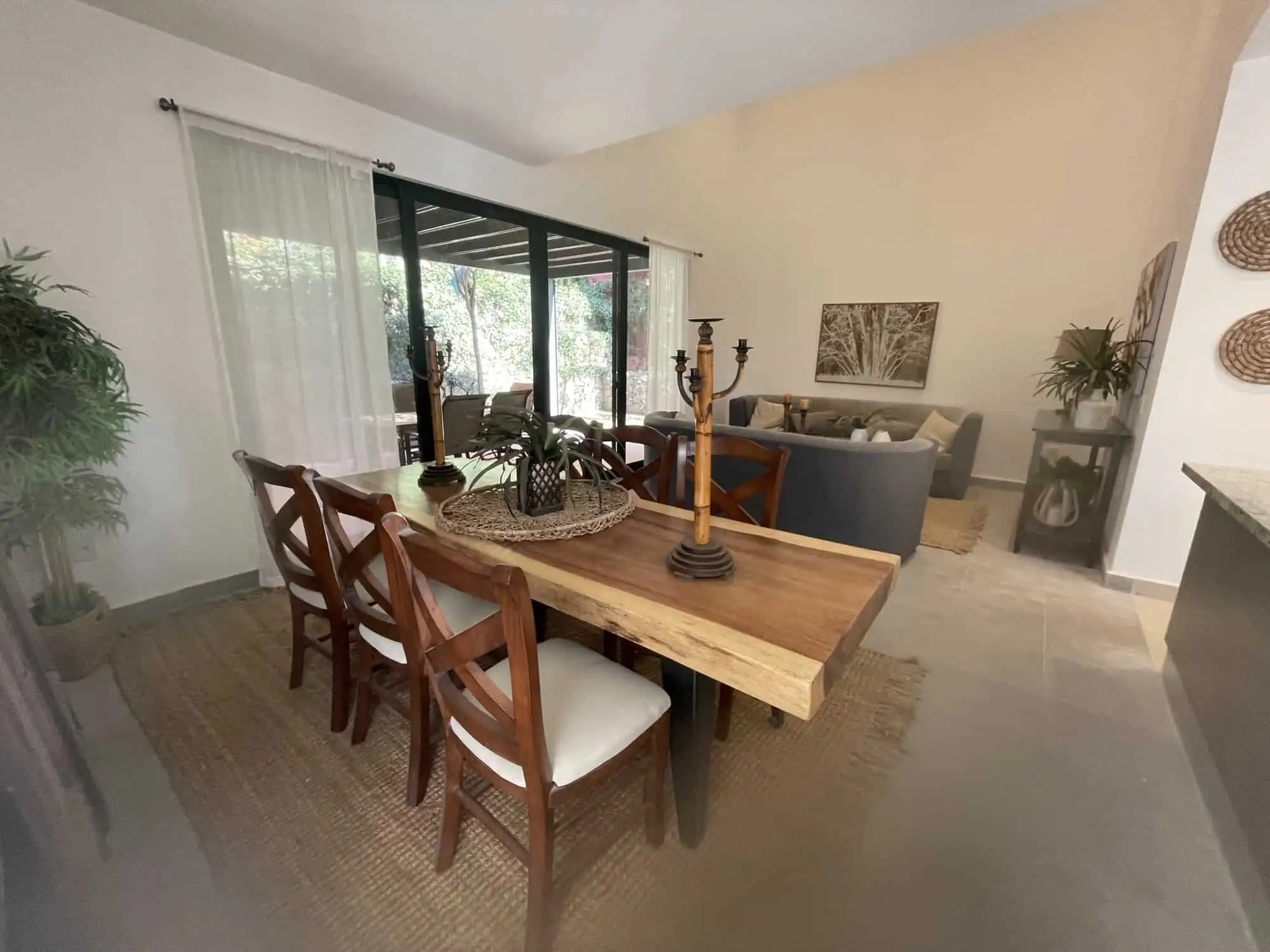 Spacious living room with modern decor, large windows, and access to outdoor views.