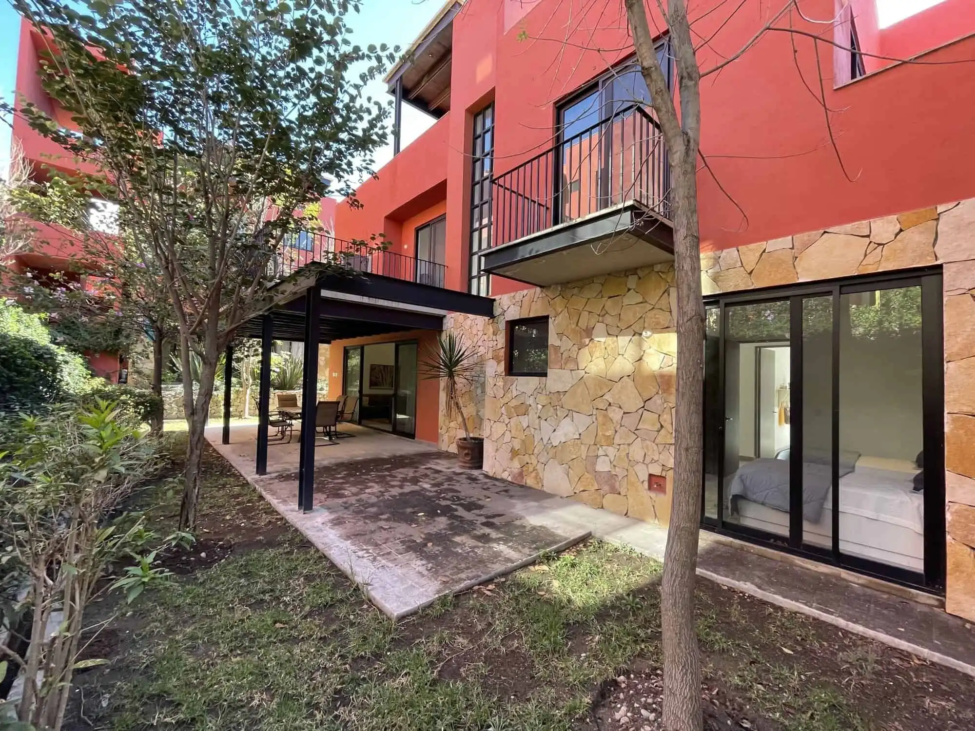 Spacious exterior view of a luxury 4-bedroom house with a terrace and lush garden in San Miguel de A.