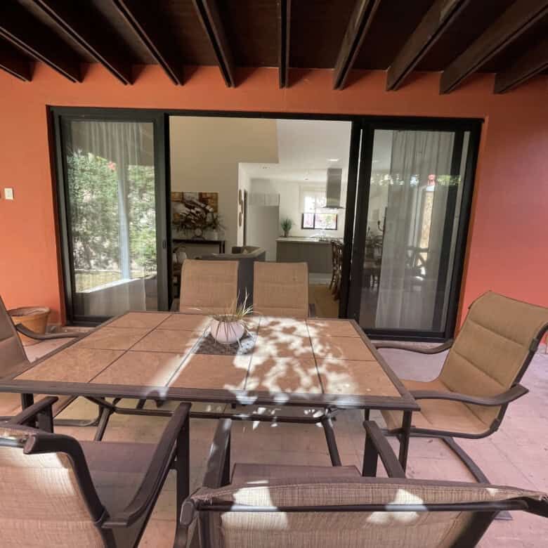 Spacious outdoor patio with dining table and comfortable chairs in a luxury home in San Miguel de Al.