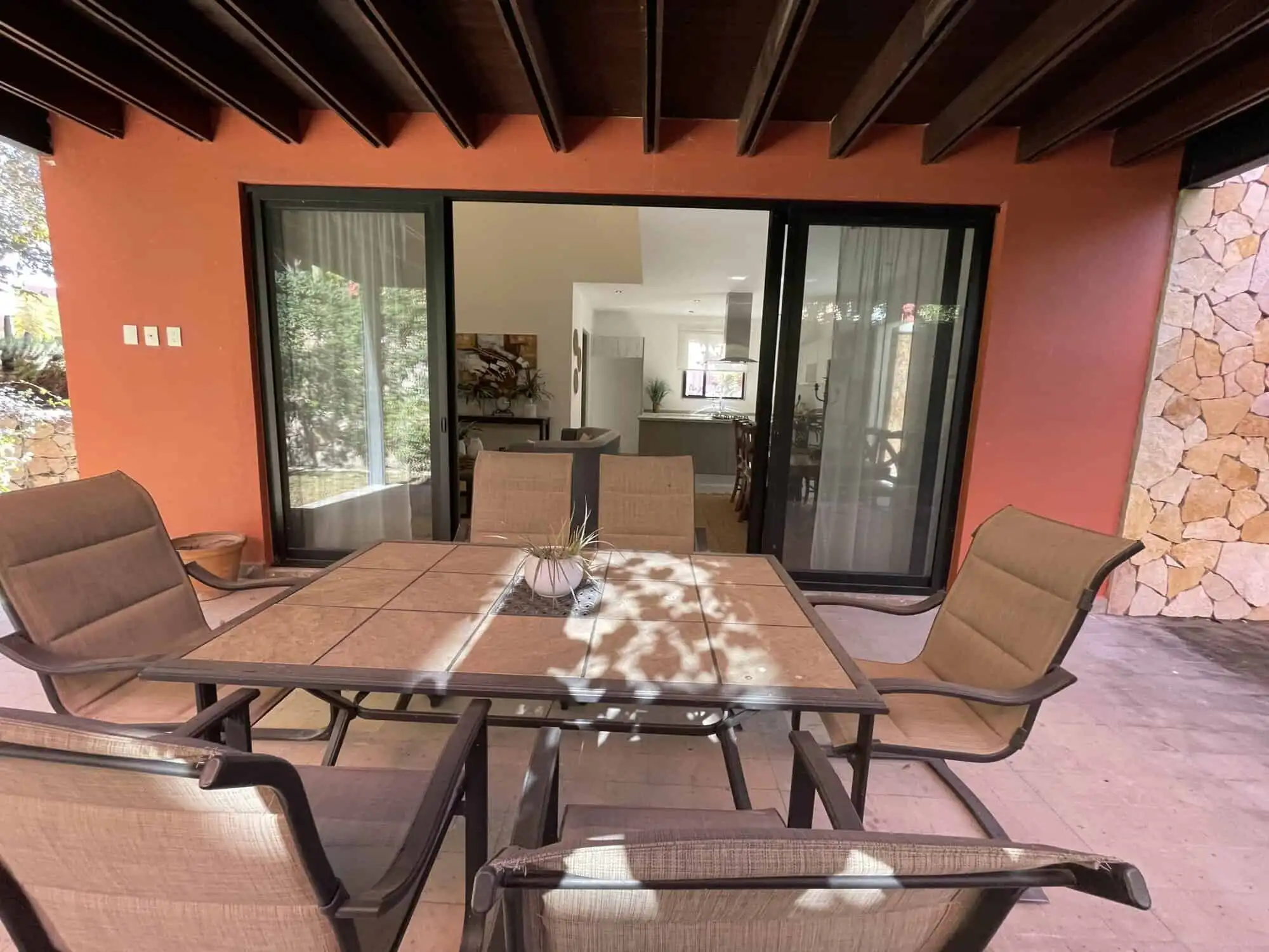 Spacious outdoor patio with dining table and comfortable chairs in a luxury home in San Miguel de Al.