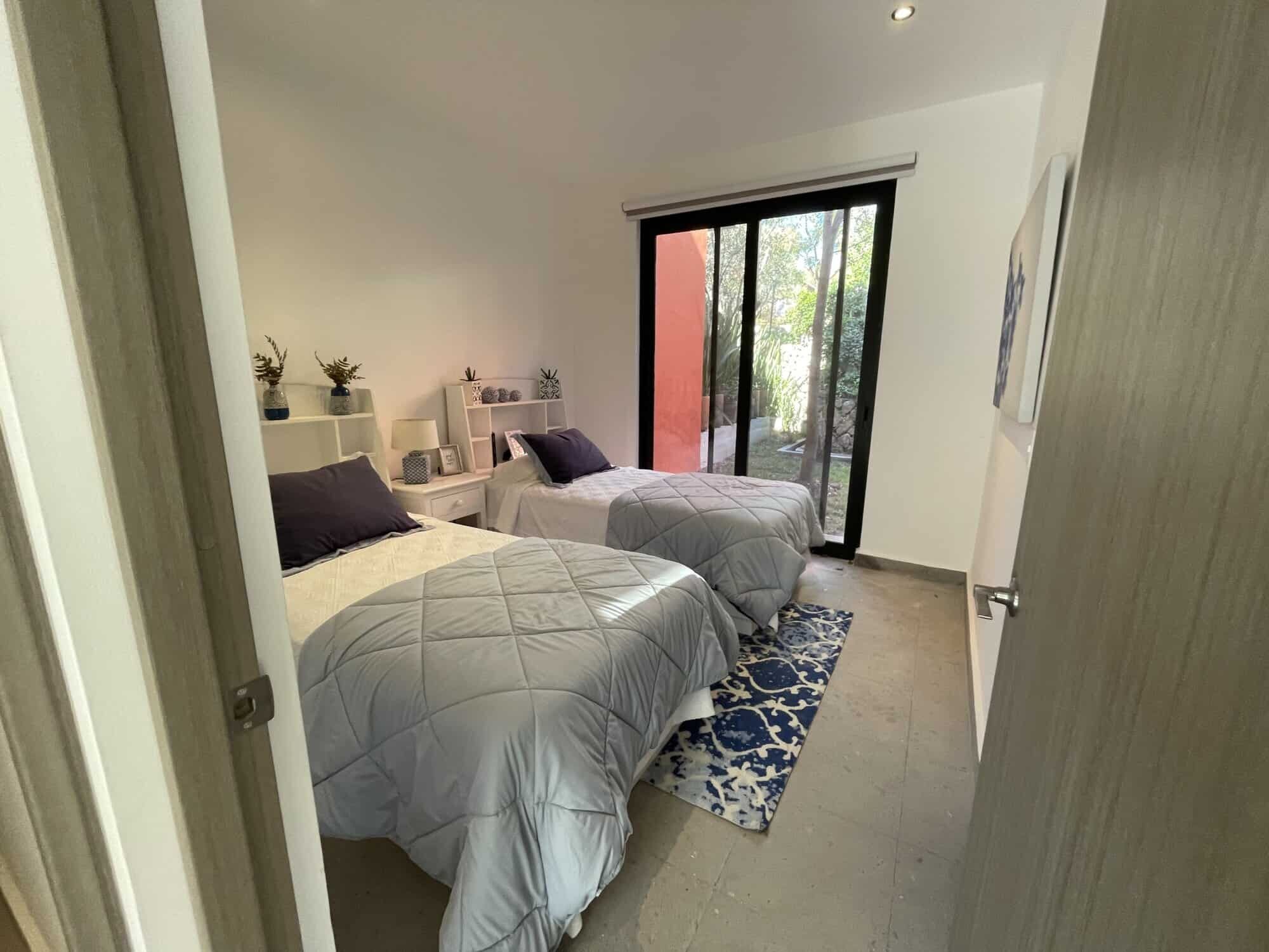 Spacious bedroom with modern decor and natural light, perfect for comfortable living in a luxury pro.