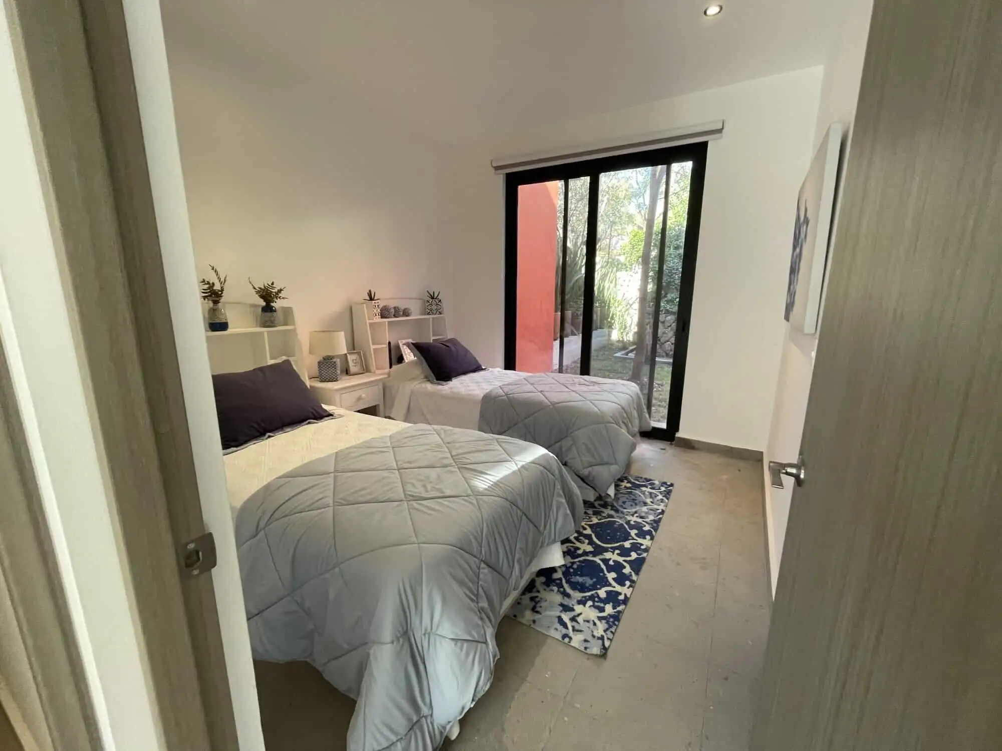 Spacious bedroom with modern decor and natural light, perfect for comfortable living in a luxury pro.