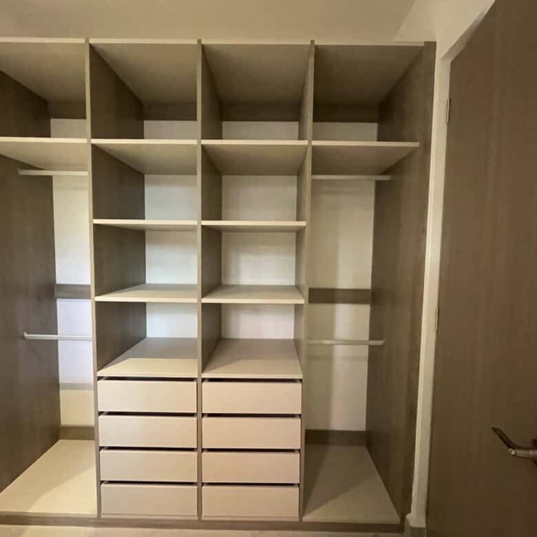 In closet featuring wooden shelves and drawers in a high-end San Miguel de Allende home.