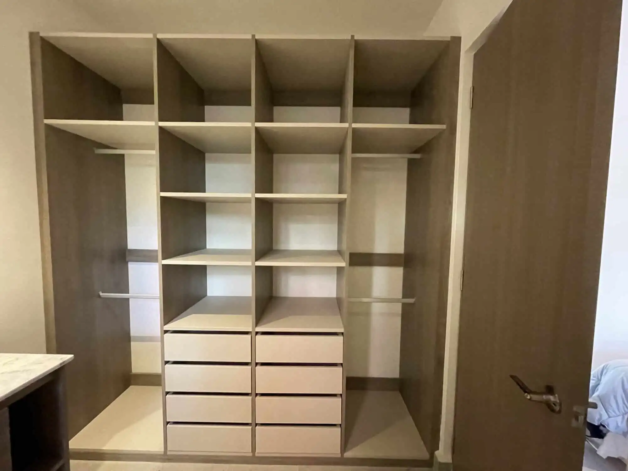 In closet featuring wooden shelves and drawers in a high-end San Miguel de Allende home.