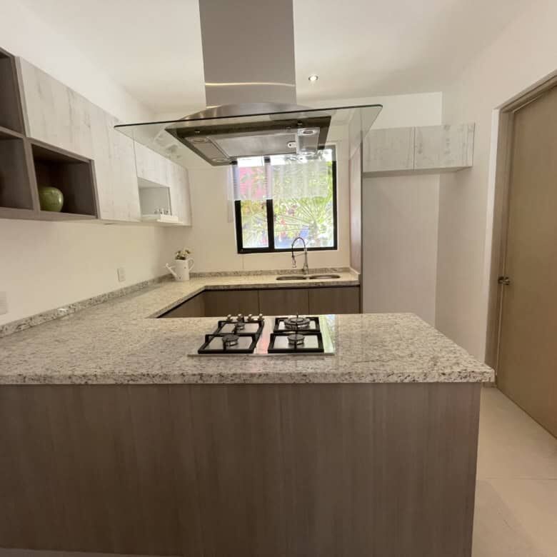 Bright, airy kitchen with granite countertops and ample storage space. Perfect for comfortable livin.