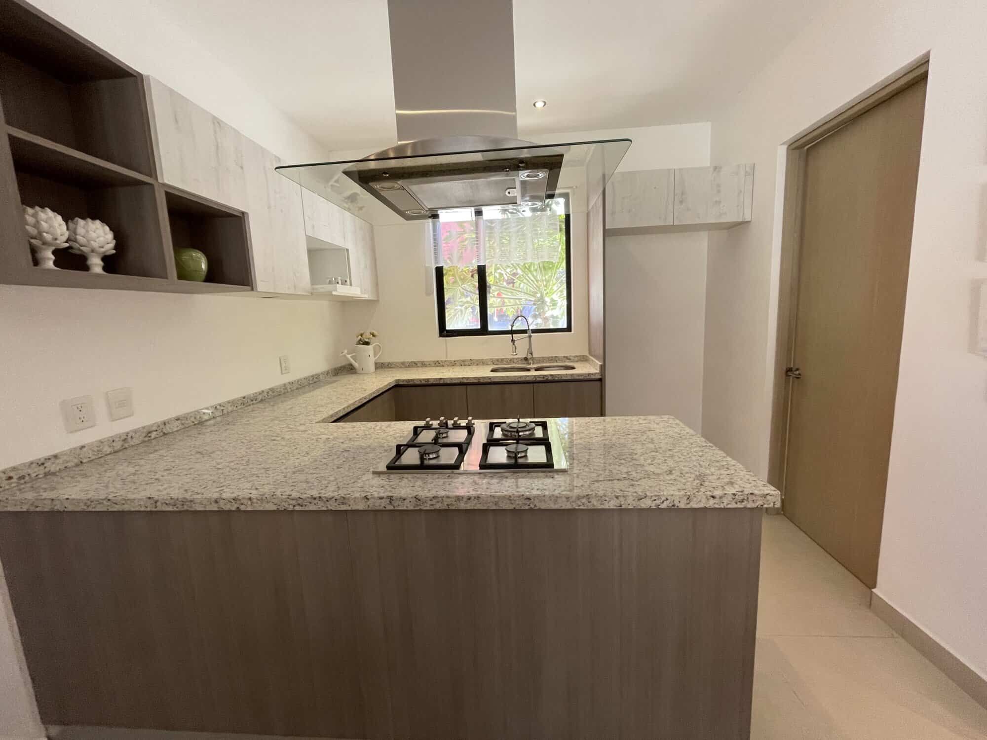 Bright, airy kitchen with granite countertops and ample storage space. Perfect for comfortable livin.