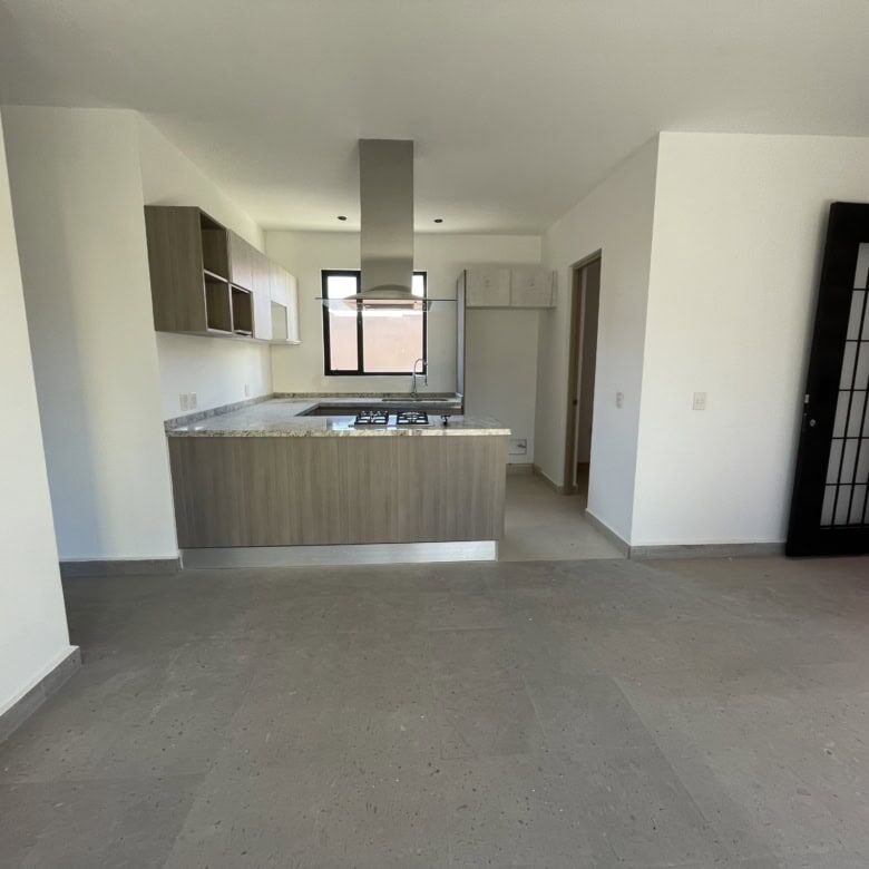 Spacious interior of a penthouse condo with contemporary kitchen and bright living area in San Migue.