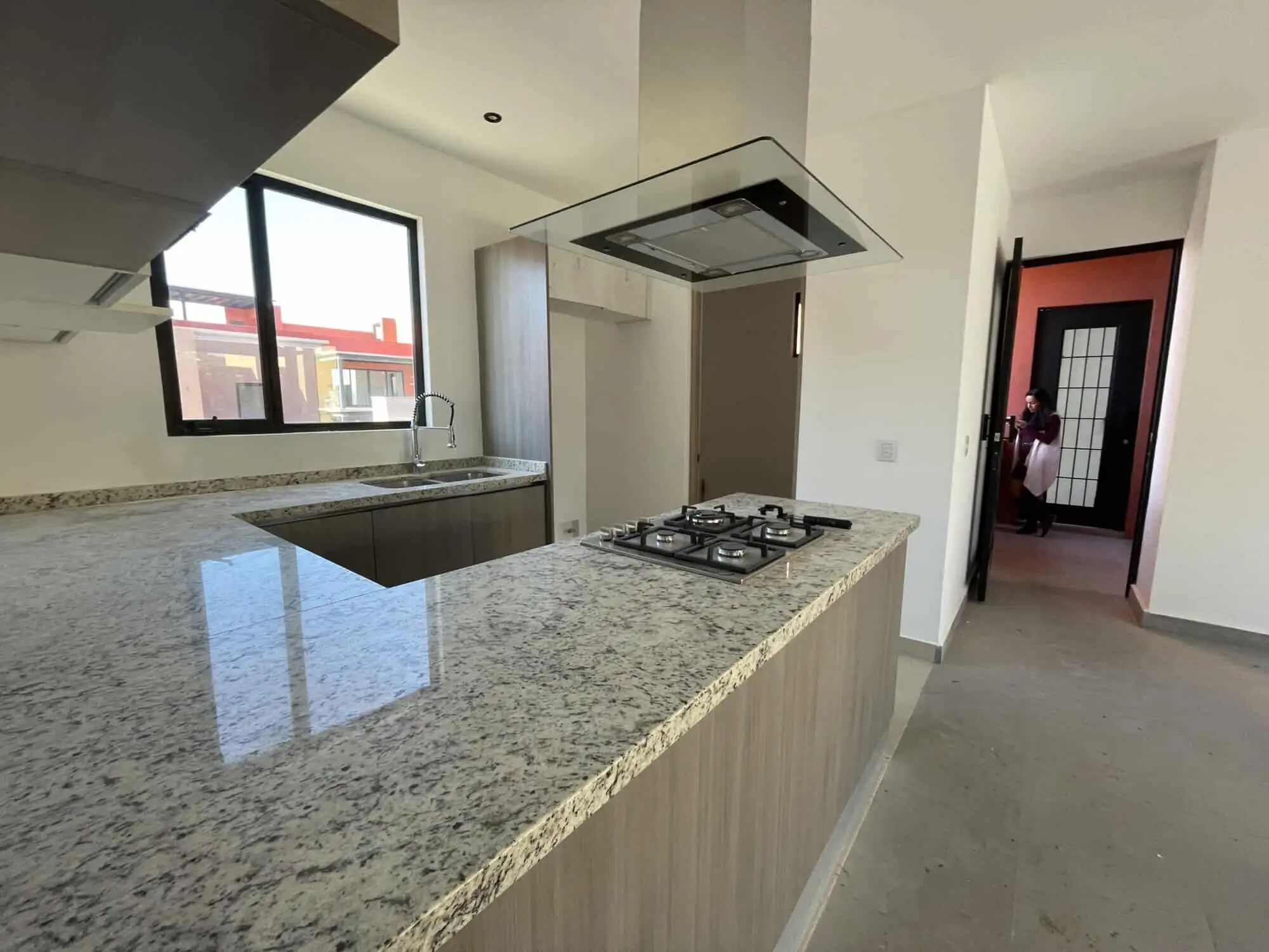 Modern kitchen with granite countertops in a luxury penthouse condo. Luxury penthouse kitchen with granite countertops and large window views.