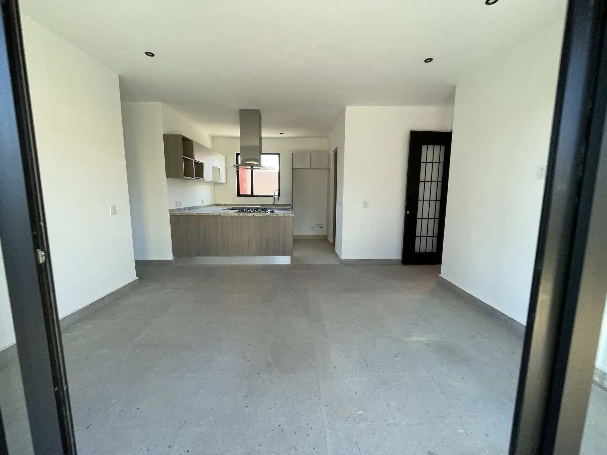 plan living space with kitchen in San Miguel de Allende. Spacious interior of a penthouse condo featuring a contemporary kitchen and bright living area.