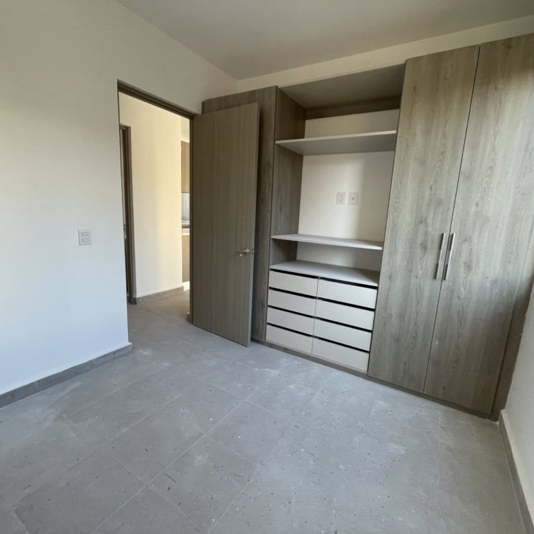 Spacious bedroom featuring a sleek built-in wardrobe and ample natural light.