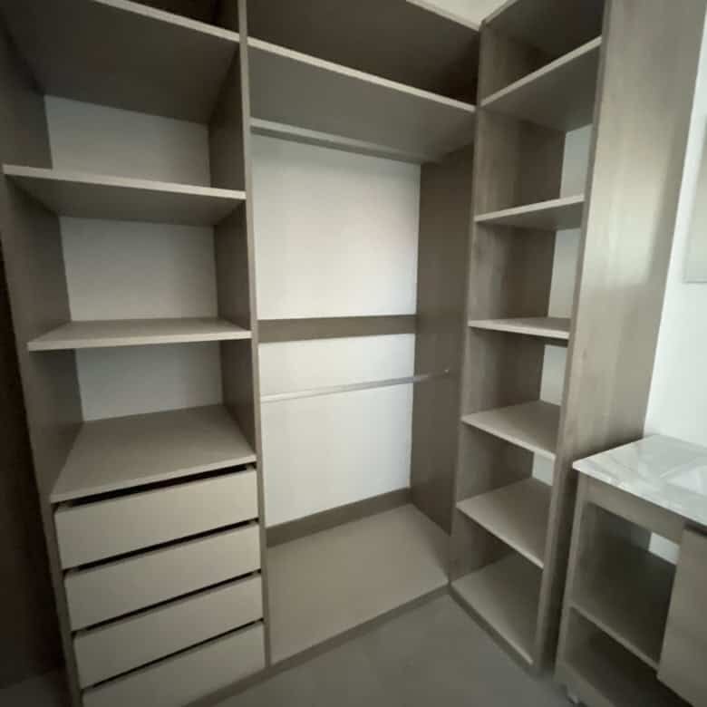 In closet with multiple shelves and drawers for organized storage.