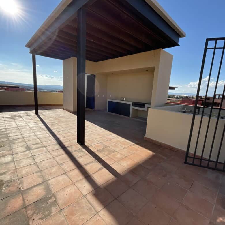 Rooftop terrace of a penthouse condo with shaded area and city views in San Miguel de Allende.