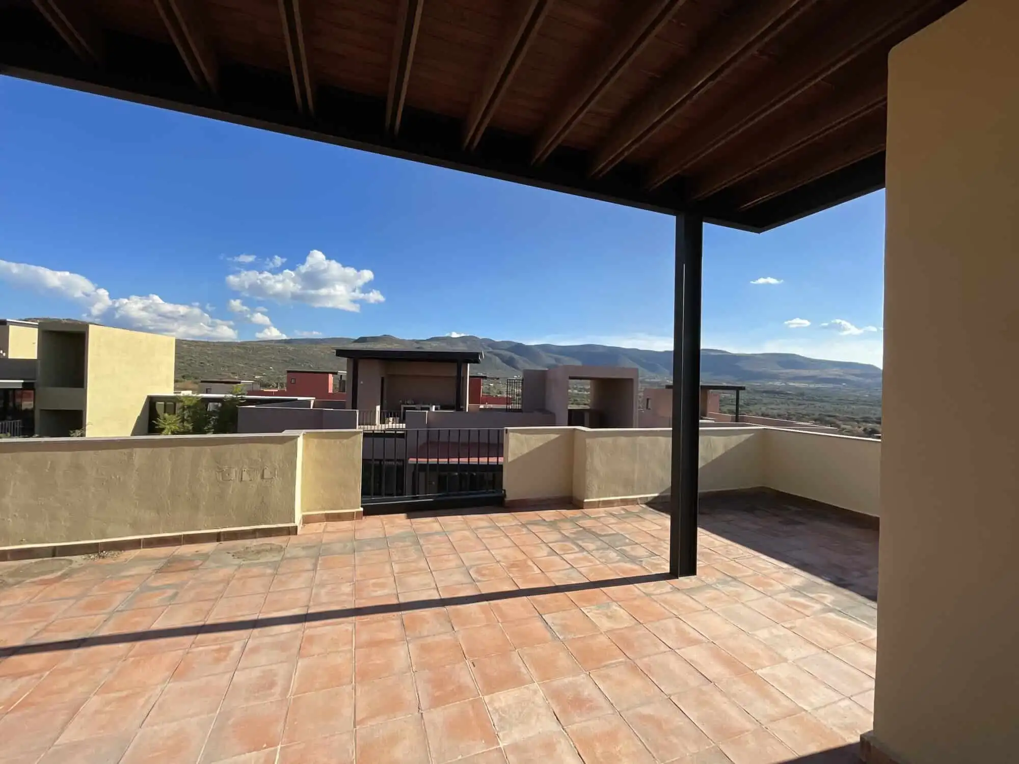 Penthouse Condo with Private Rooftop Spacious rooftop terrace of a penthouse condo in San Miguel de Allende with scenic mountain views.