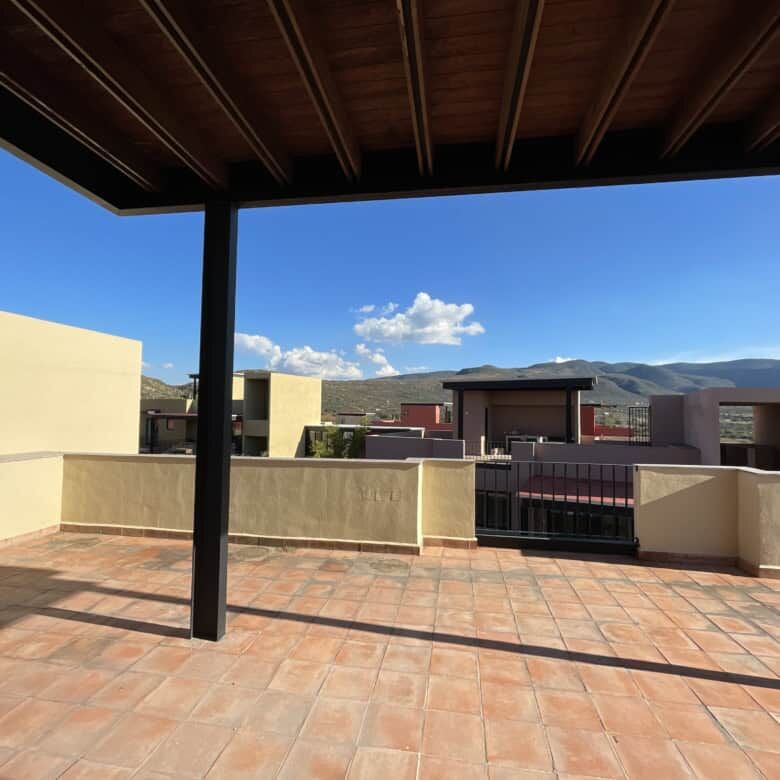 Stunning rooftop terrace of a penthouse condo in San Miguel de Allende with panoramic mountain views.