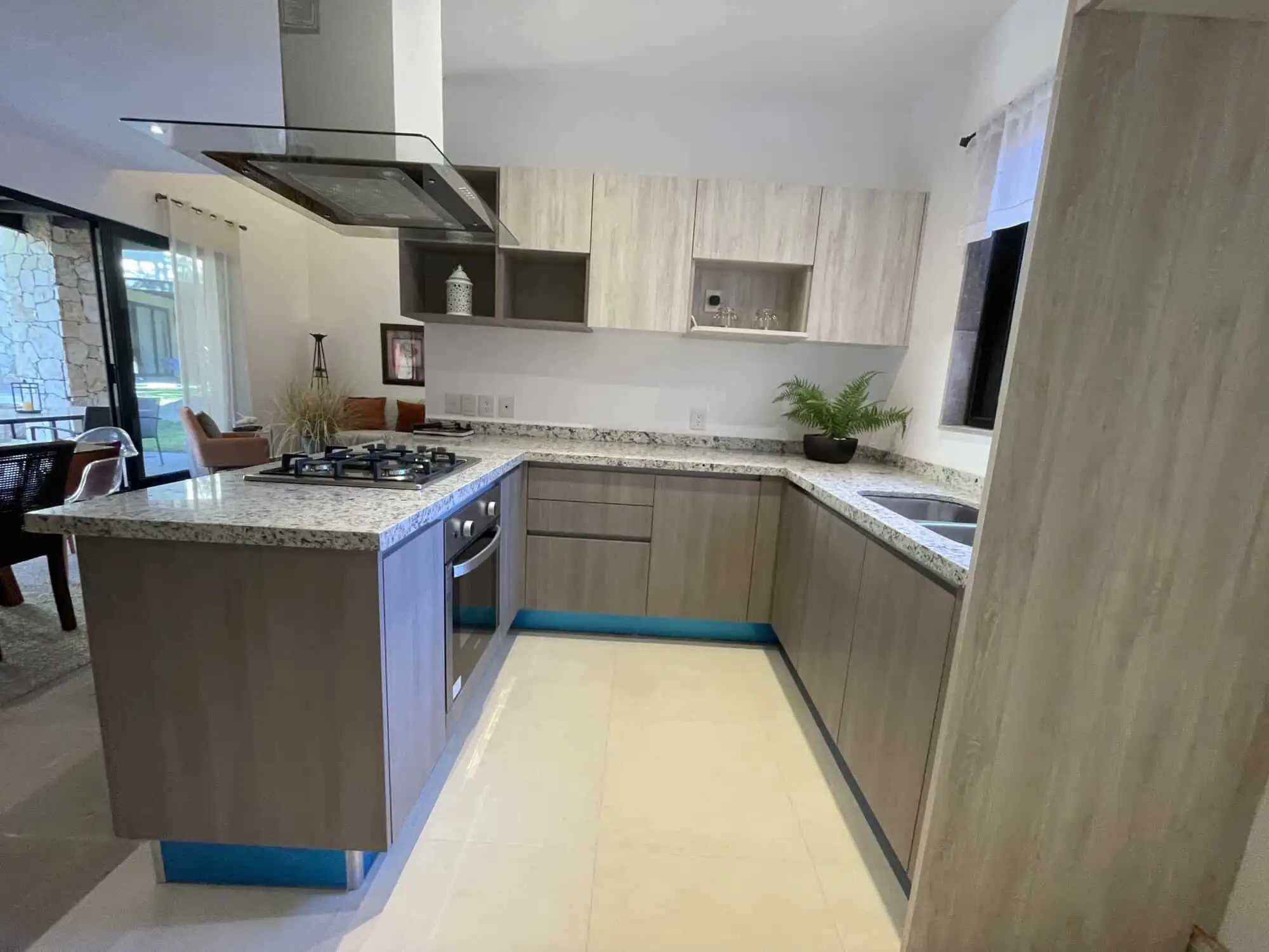 Modern kitchen with light wood cabinets and granite countertops in a luxury home. Luxury 3-Bedroom Home Kitchen in Punta del Cielo, San Miguel de Allende.