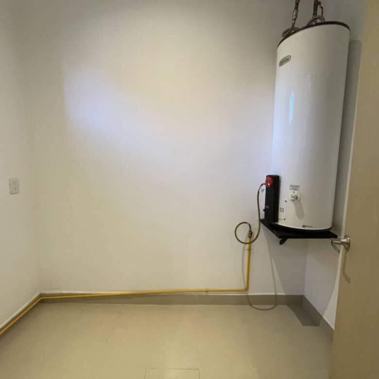 Elegant interior view of a modern Punta del Cielo home with water heater and clean, spacious room.