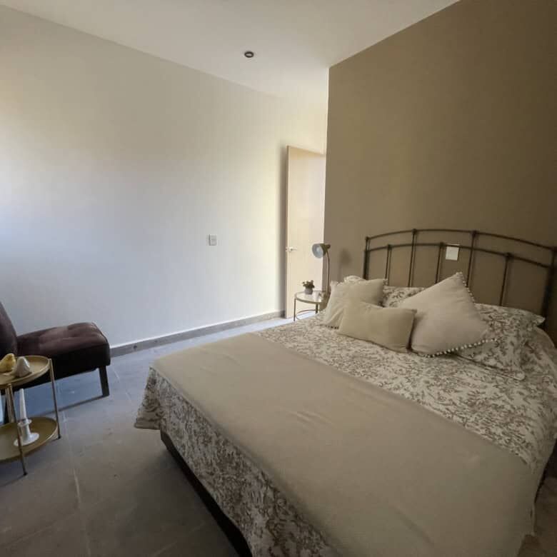 Elegant bedroom with a cozy bed and modern decor in Punta del Cielo.