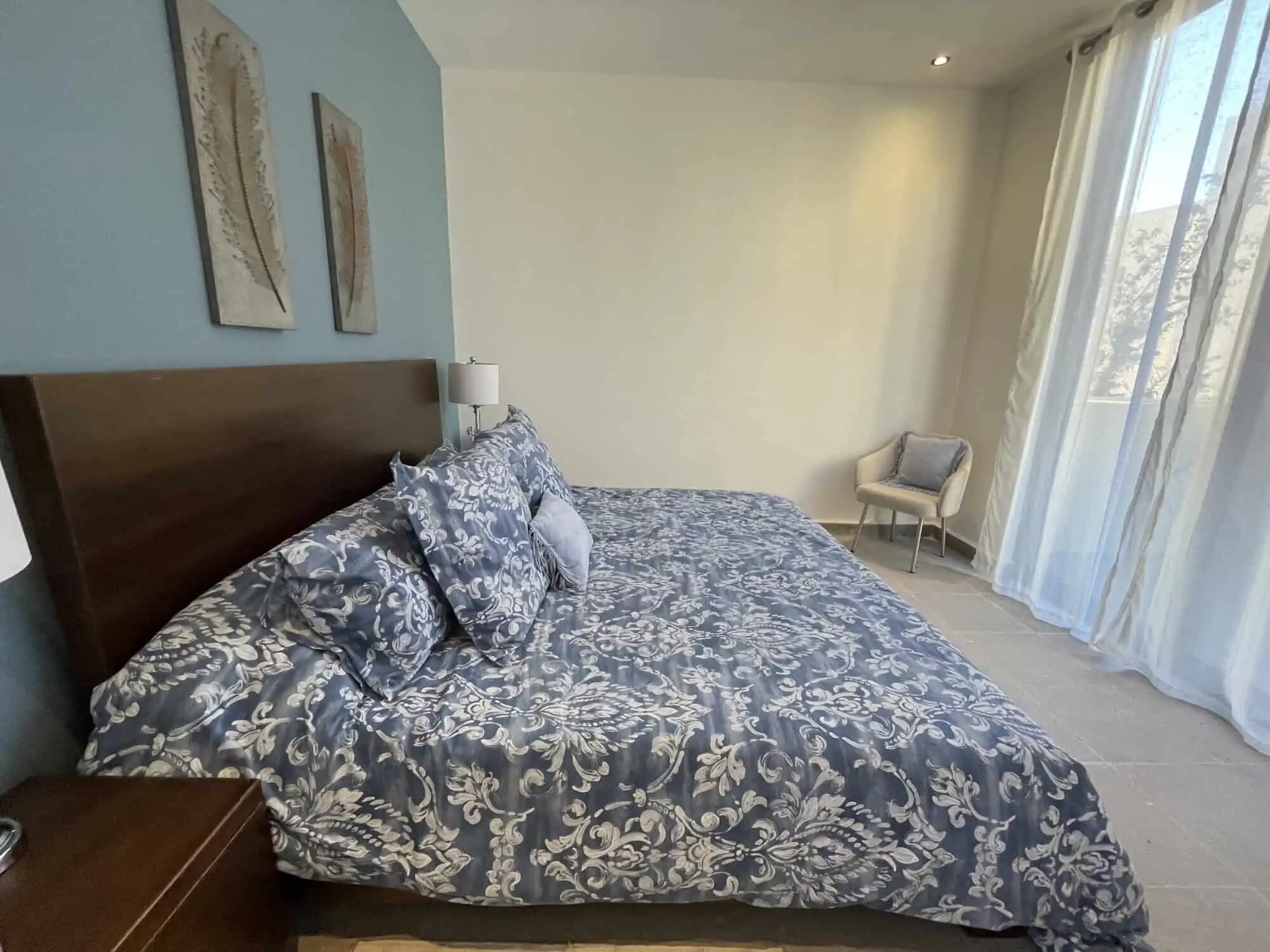 Luxury 3-Bedroom Home in Punta del Cielo Spacious bedroom with elegant decor and large windows in Punta del Cielo, San Miguel de Allende.