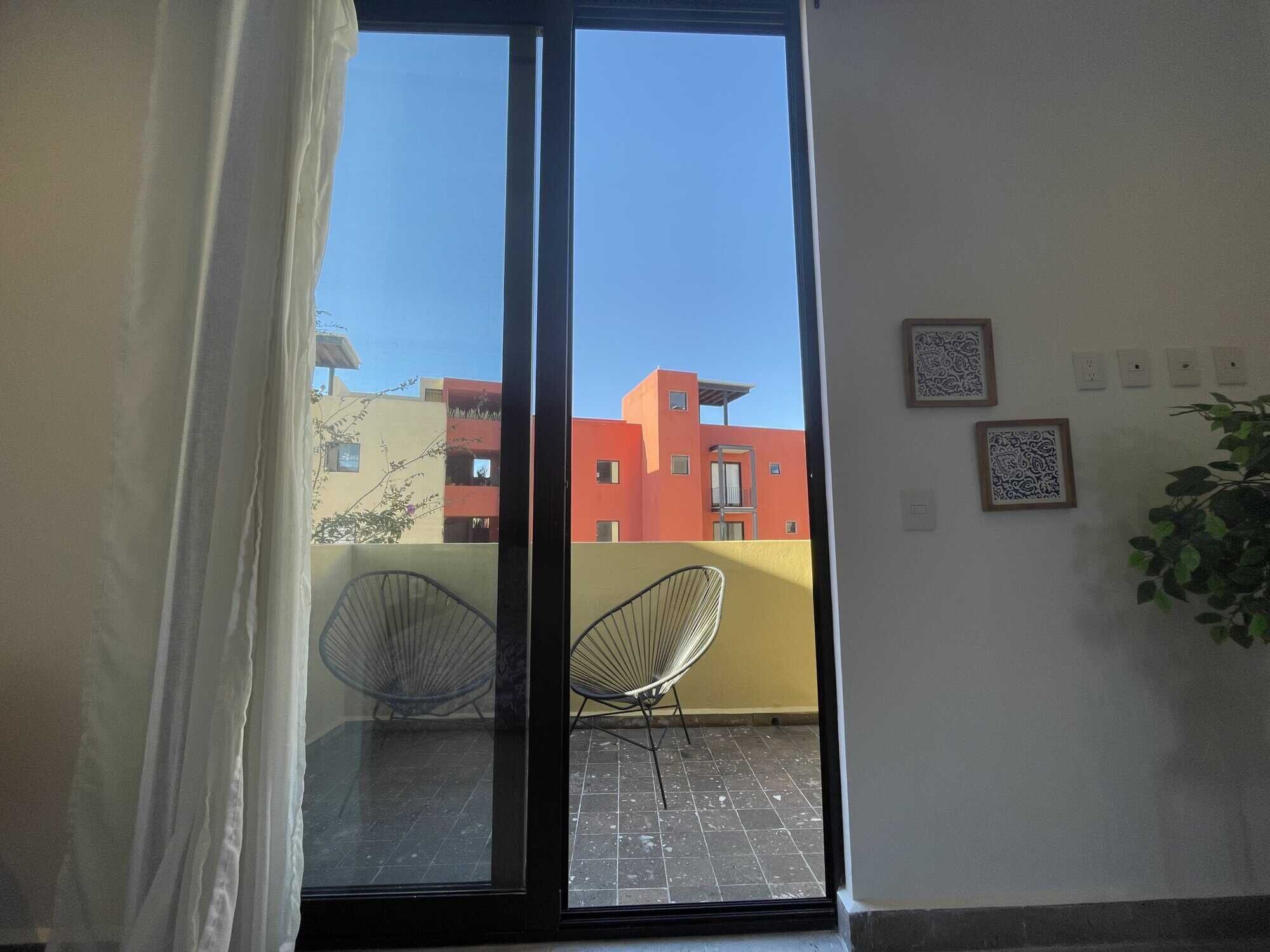 Bright living room with large glass doors opening to a balcony in Punta del Cielo. Modern design and.