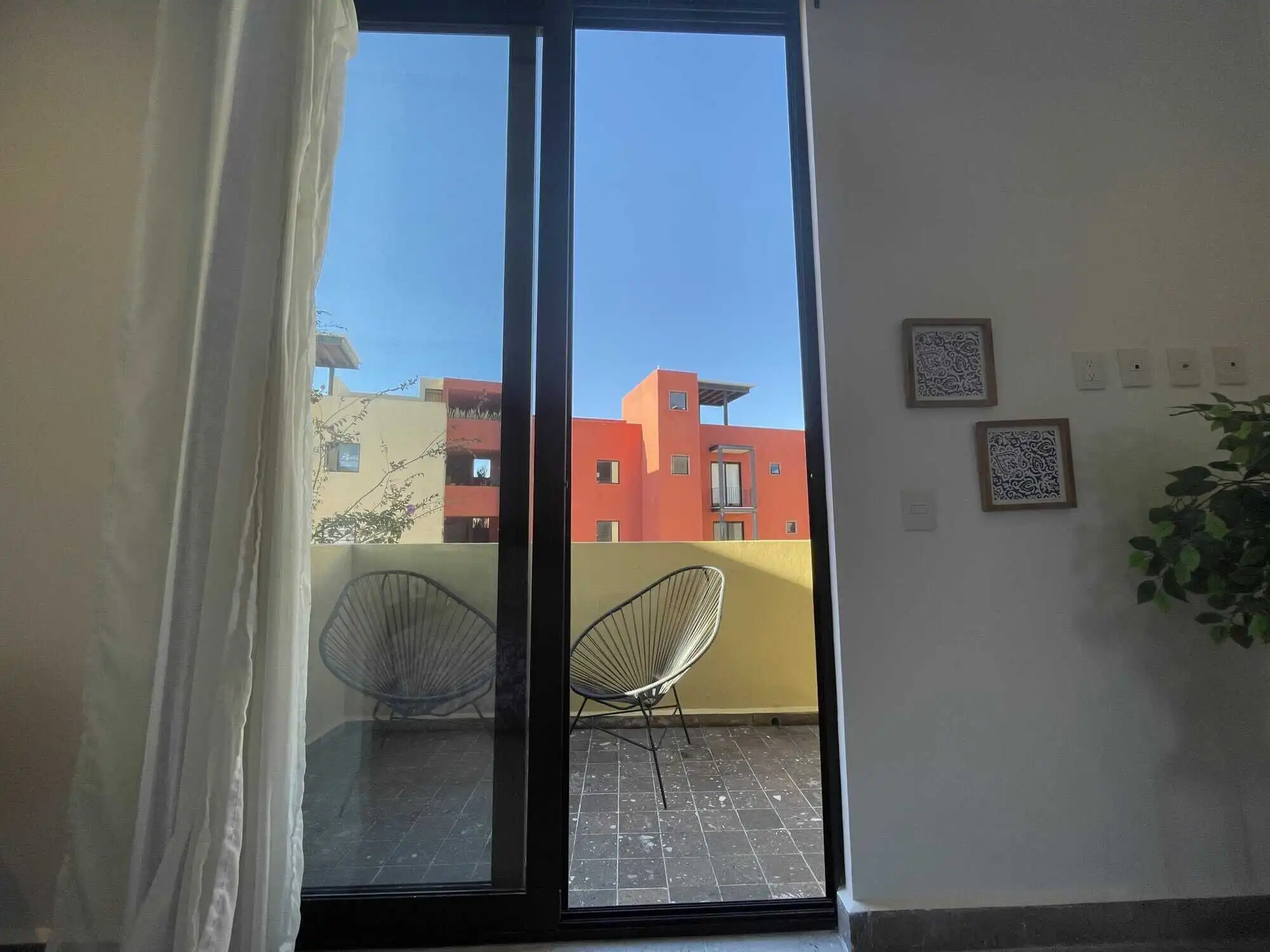 Luxury 3-Bedroom Home in Punta del Cielo Bright living room with large glass doors opening to a balcony in Punta del Cielo. Modern design and.