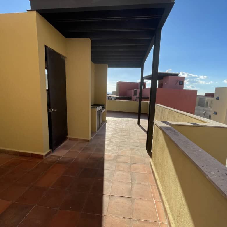Spacious balcony with modern design and city views in a luxury home in Punta del Cielo.