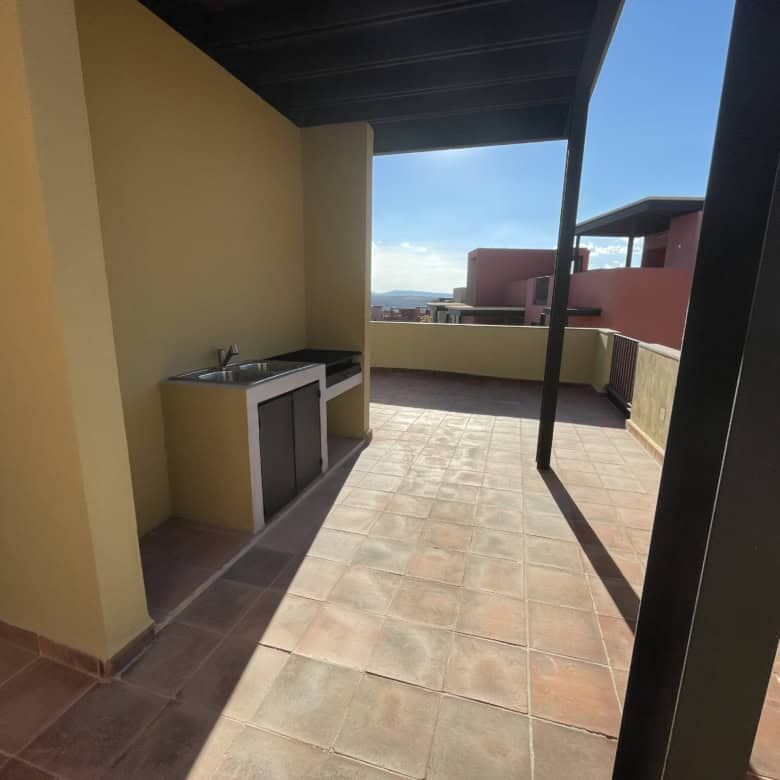Rooftop terrace with outdoor kitchen and city views in San Miguel de Allende.