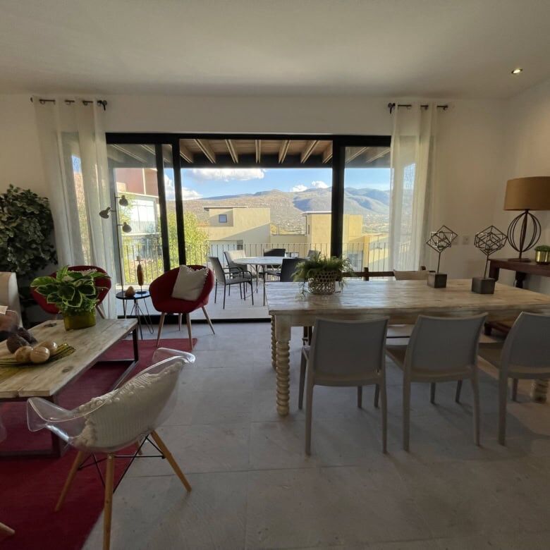 Elegant living room with large windows and scenic views in Punta del Cielo penthouse.