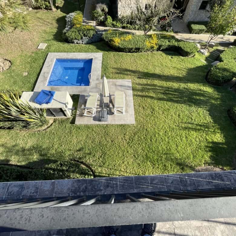 Spacious backyard with private pool and outdoor seating in Punta del Cielo penthouse.
