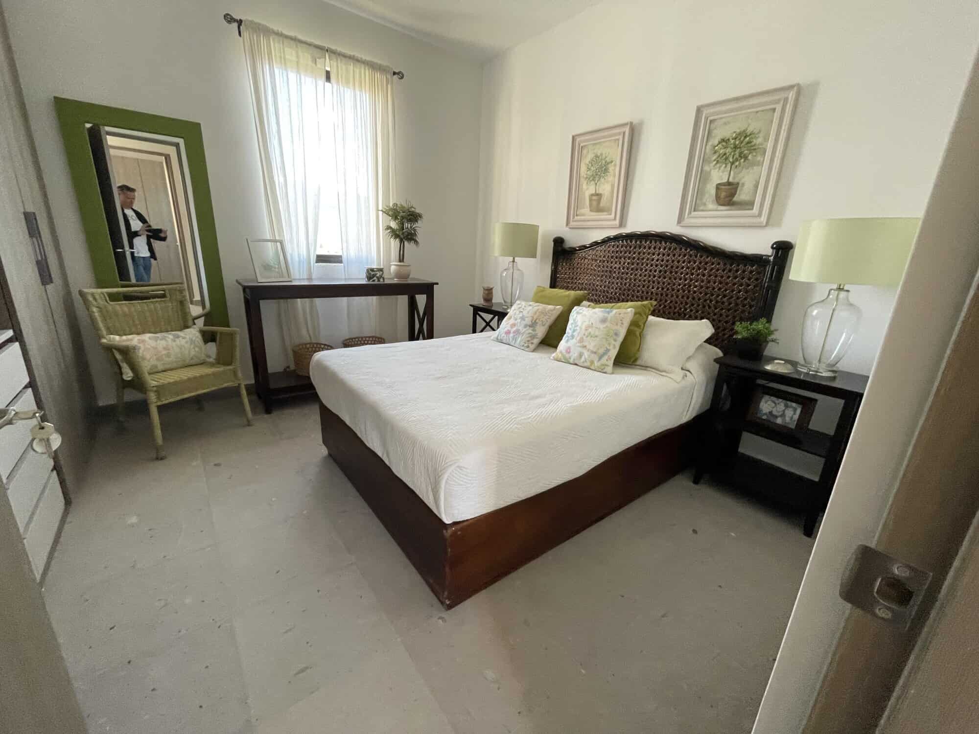 Spacious bedroom with elegant decor, large window, and natural light in Punta del Cielo penthouse.