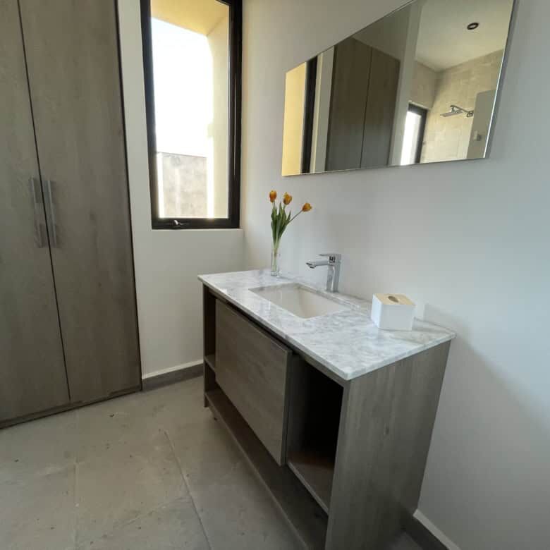 Elegant bathroom with modern fixtures and natural light in Punta del Cielo penthouse.