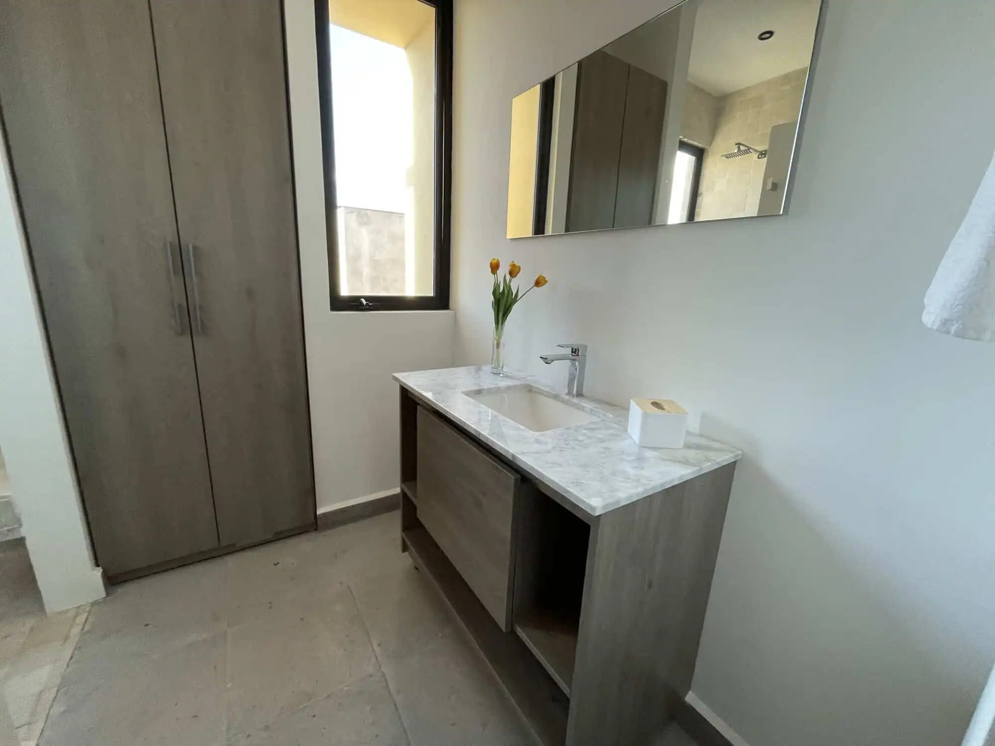Elegant bathroom with modern fixtures and natural light in Punta del Cielo penthouse.