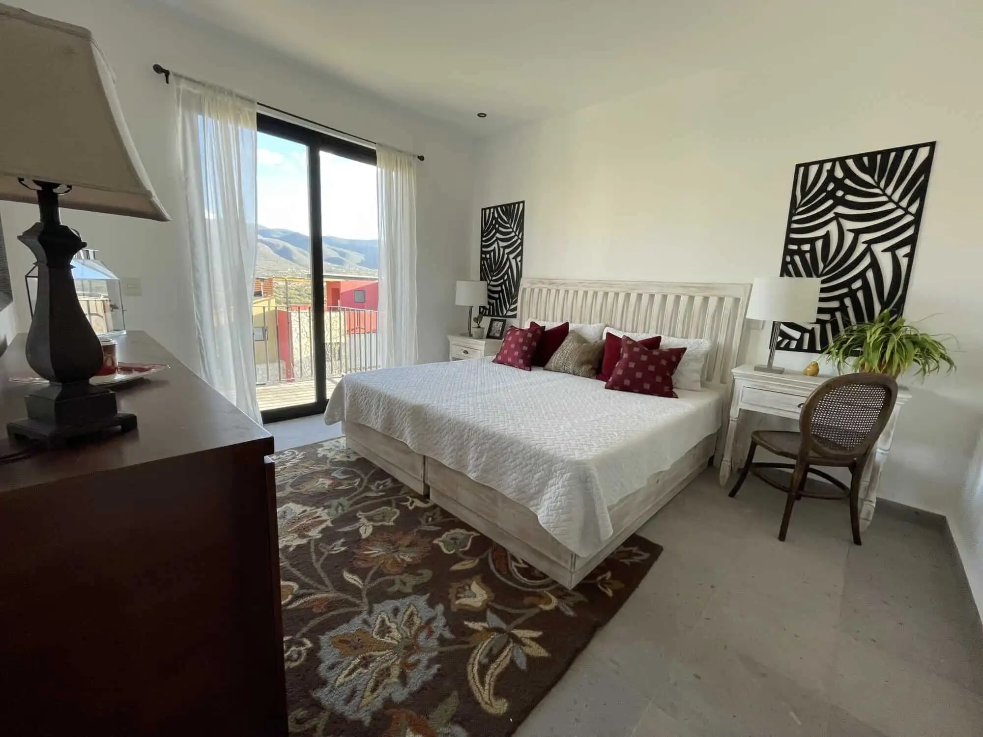 Spacious bedroom with modern decor and balcony views in Punta del Cielo, San Miguel de Allende.