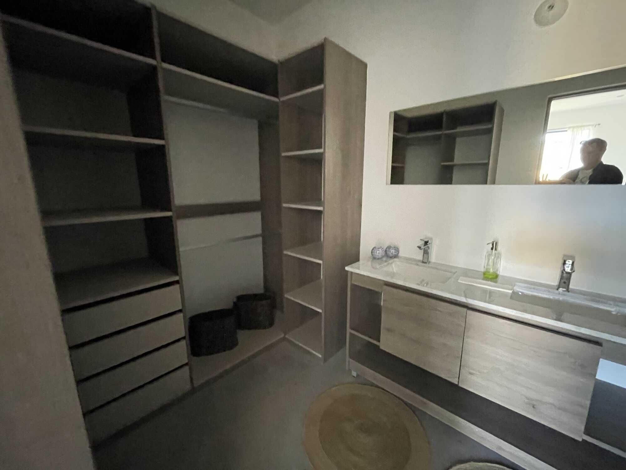 Elegant bathroom with modern fixtures and ample storage space.