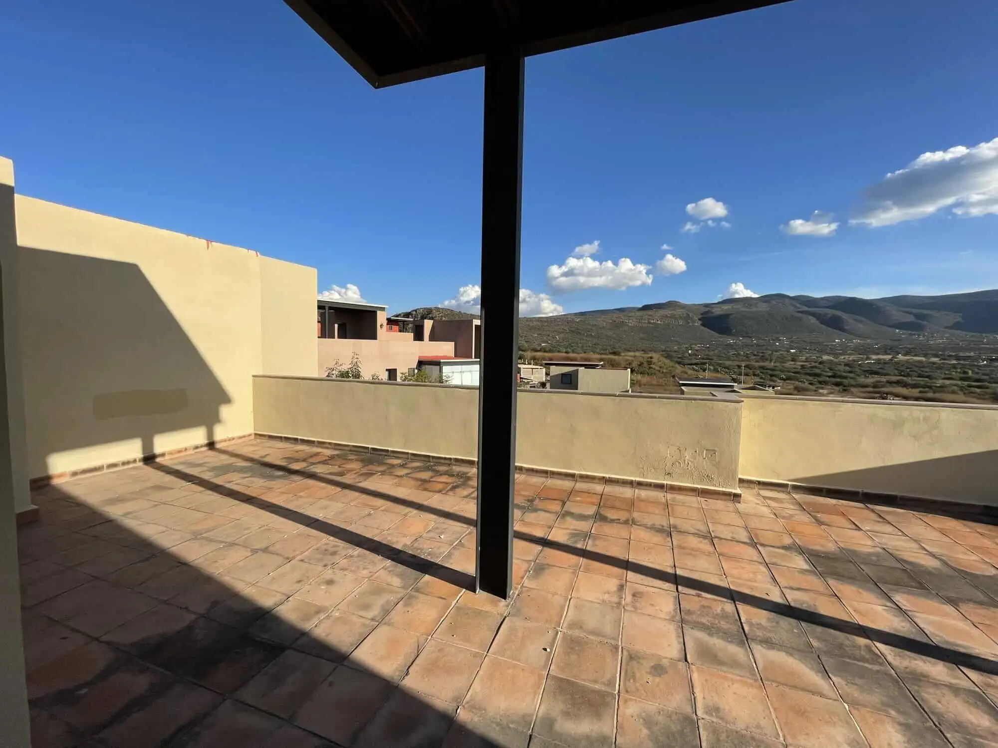 Spacious terrace of a luxury 2-bedroom penthouse in Punta del Cielo, San Miguel de Allende, with sce.